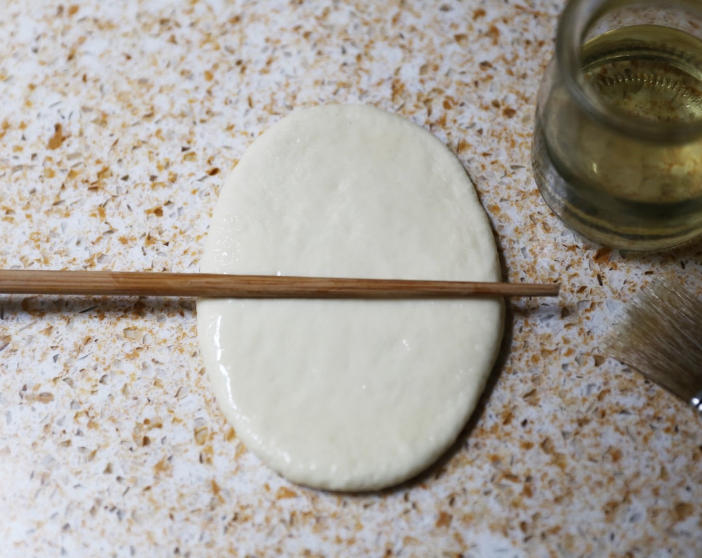 step 13 Rub a chopstick with more sunflower oil  and place in the centre of the dough.