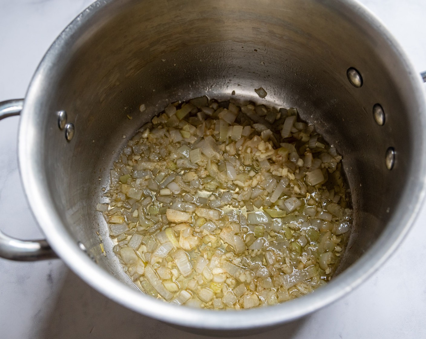 step 1 In a large saucepan, melt the Unsalted Butter (1/4 cup) over medium heat. Add the Onion (1) and cook for 3 minutes, or until translucent. Stir in the Garlic (3 cloves) and sauté for 30 seconds longer.