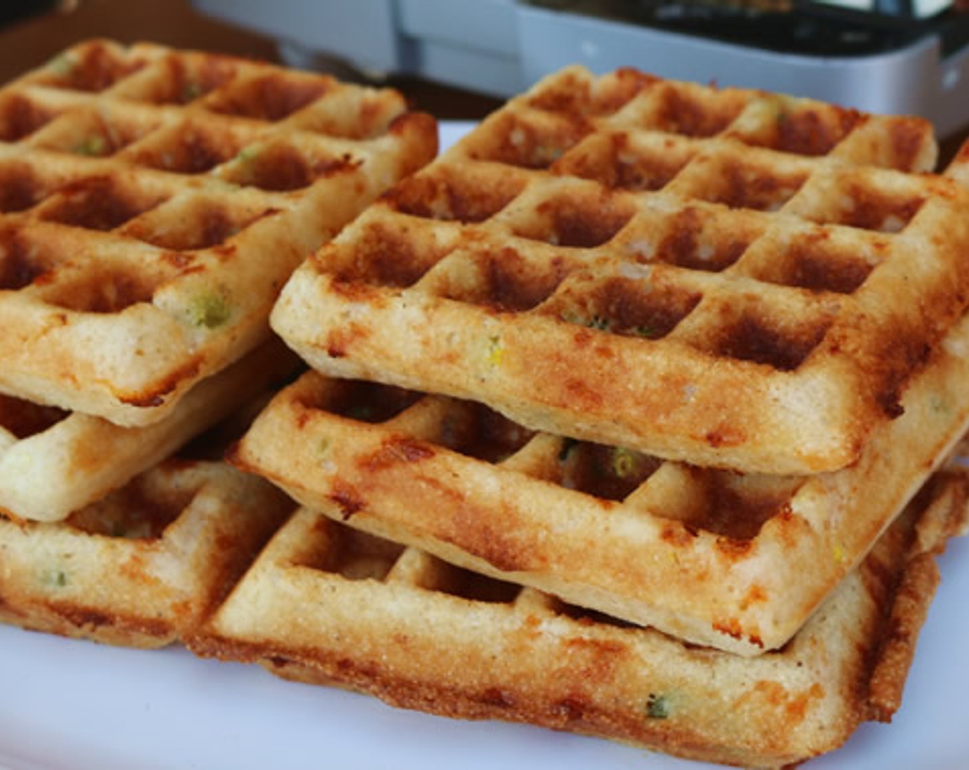 step 8 Preheat a waffle iron, lightly grease with Nonstick Cooking Spray (as needed), and scoop 1/2 cup of the batter into each side of the waffle iron. Cook the waffles for 15 minutes, or until golden brown.