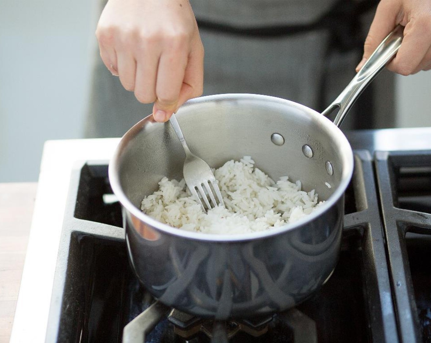 step 2 Bring to a boil, cover and reduce heat to low. Simmer for 15 minutes. Remove from heat, fluff with a fork and set aside. Keep warm for plating, covered.