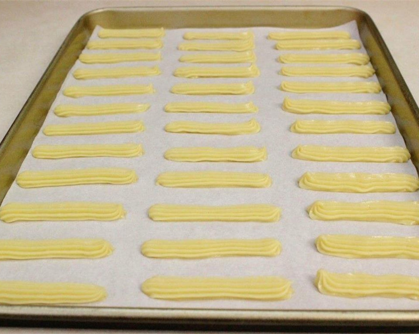step 5 Transfer the batter to a large ziptop bag or a pastry bag and pipe 2-3 inch long strips, about 1 cm thick onto the prepared baking sheet.
