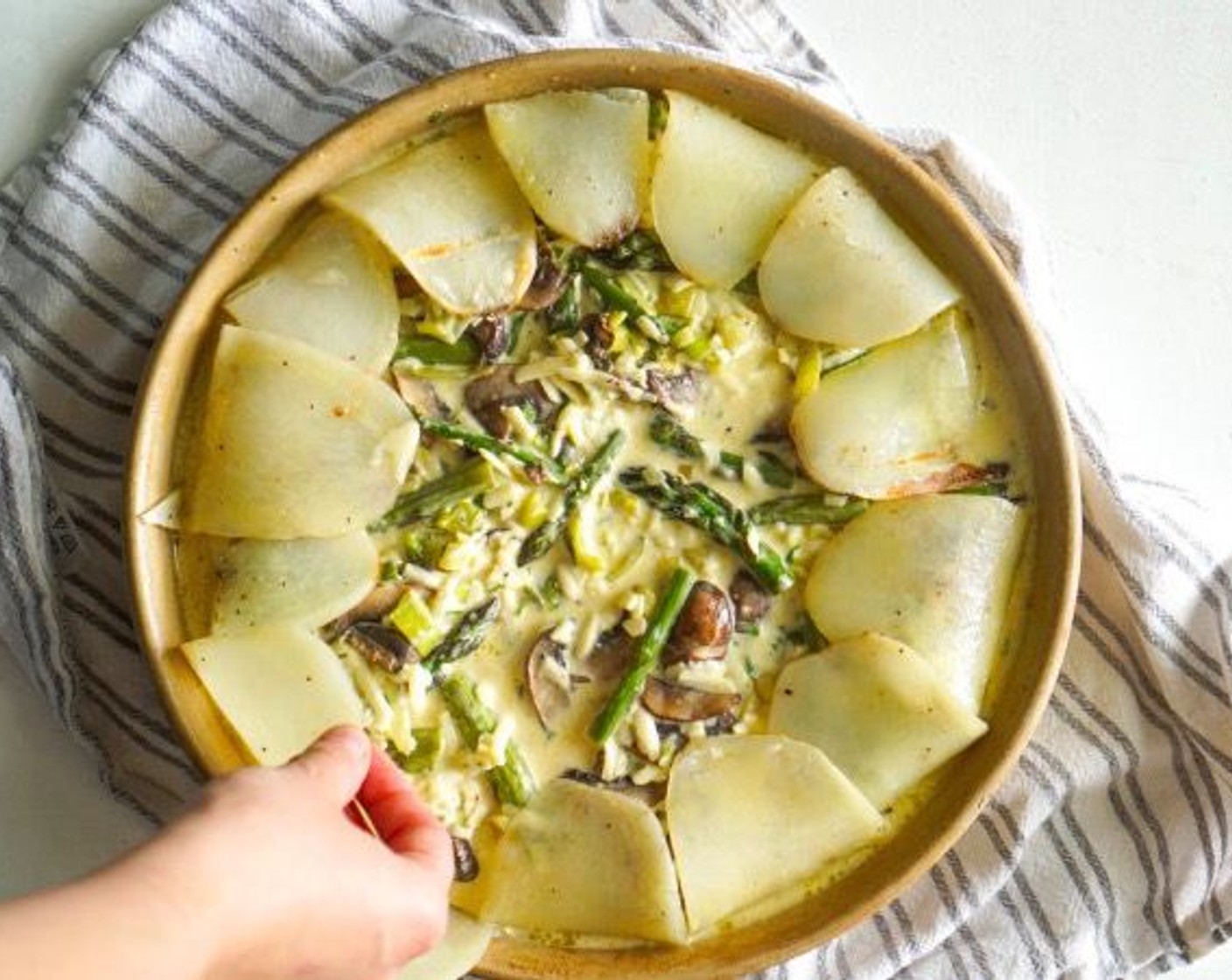 step 10 Pour into the potato-lined pan, folding over the extra 1-inch of potato to create the crust. Bake covered for 40 minutes.