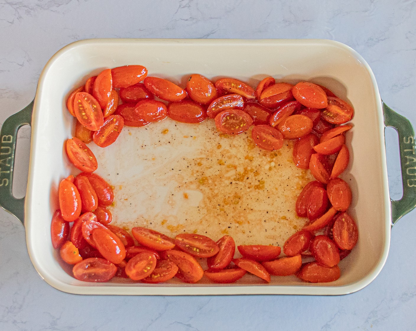 step 3 Place the tomatoes on a baking dish. Create an open space by pushing the tomatoes to the edges of the baking dish.