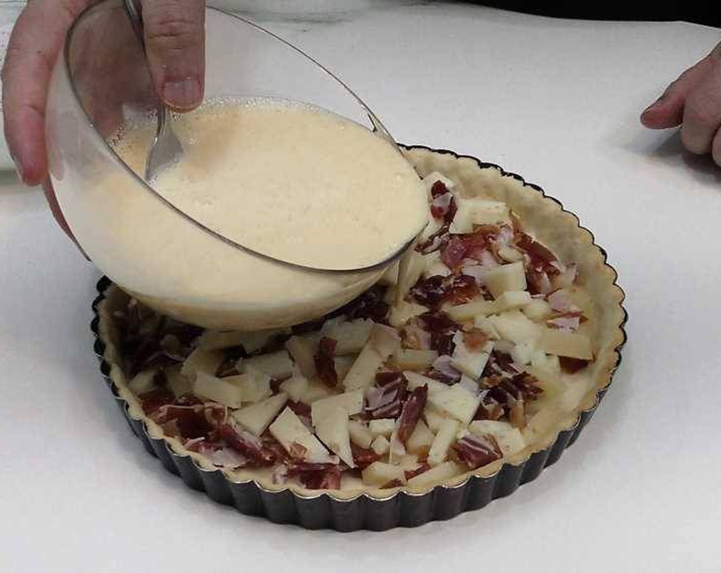 step 5 In a bowl, beat the Eggland's Best Classic Eggs (3) and then add the Cream (1 cup). Mix together, pour over the quiche, then let it settle.