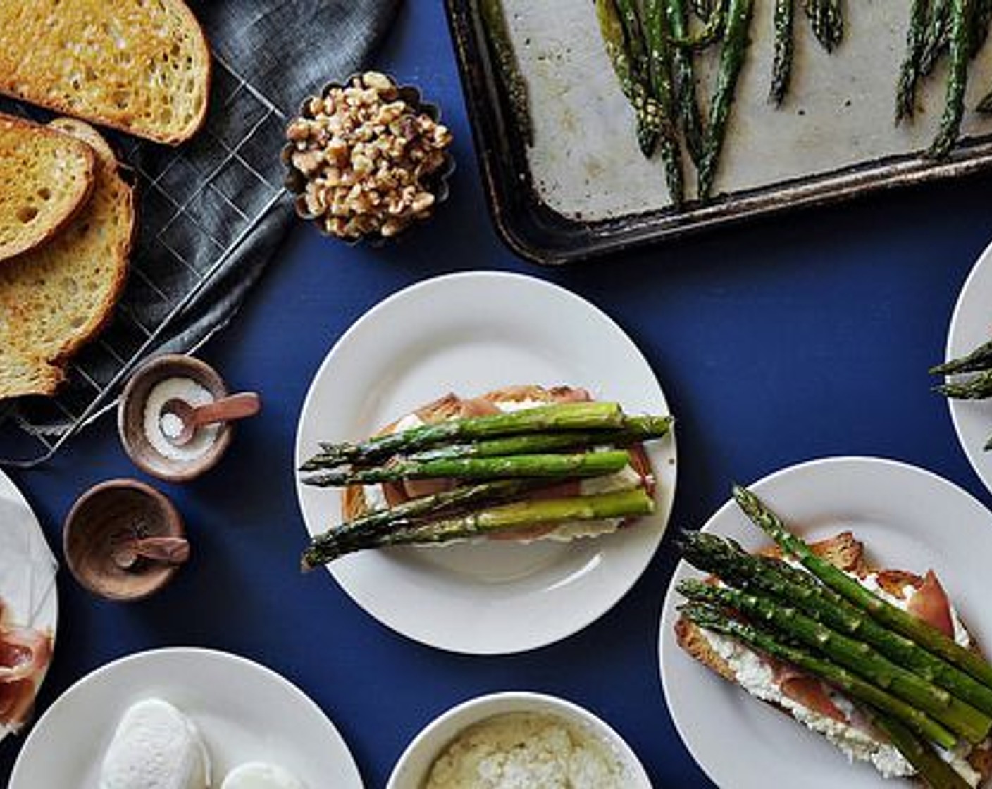 step 13 Top each half with 2 slices of Prosciutto (8 slices) and with a few spears of the roasted asparagus.