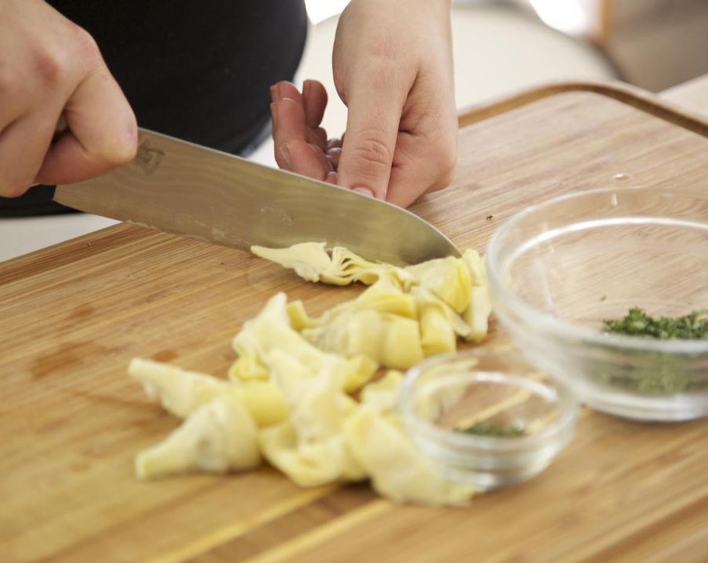 step 3 Remove the stems from the Fresh Thyme (3 1/2 Tbsp) and Fresh Parsley (3 Tbsp). Chop the leaves separately and set aside. Strain and cut Artichoke Hearts (2/3 cup) in half the set aside. Drizzle Oil (1 Tbsp) over the potatoes and toss. Roast in the oven for 15 minutes.