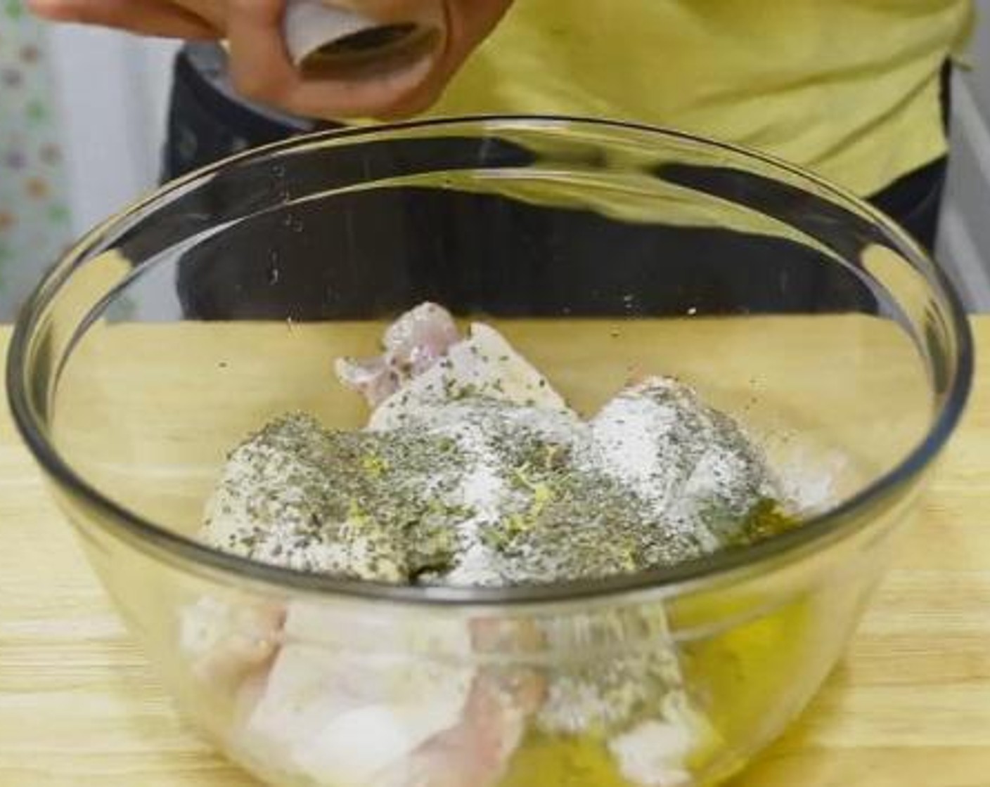 step 2 Add Chicken Thighs (2 lb), Olive Oil (4 Tbsp), juice and zest from Lemons (1 1/4), Garlic (4 cloves), Dried Oregano (2 tsp), Dried Thyme (1 tsp), Salt (2 tsp), and Freshly Ground Black Pepper (to taste) to a large bowl. Using a large spoon or your hands combine well. Add the Potatoes (8 oz) and toss them well in the marinade.