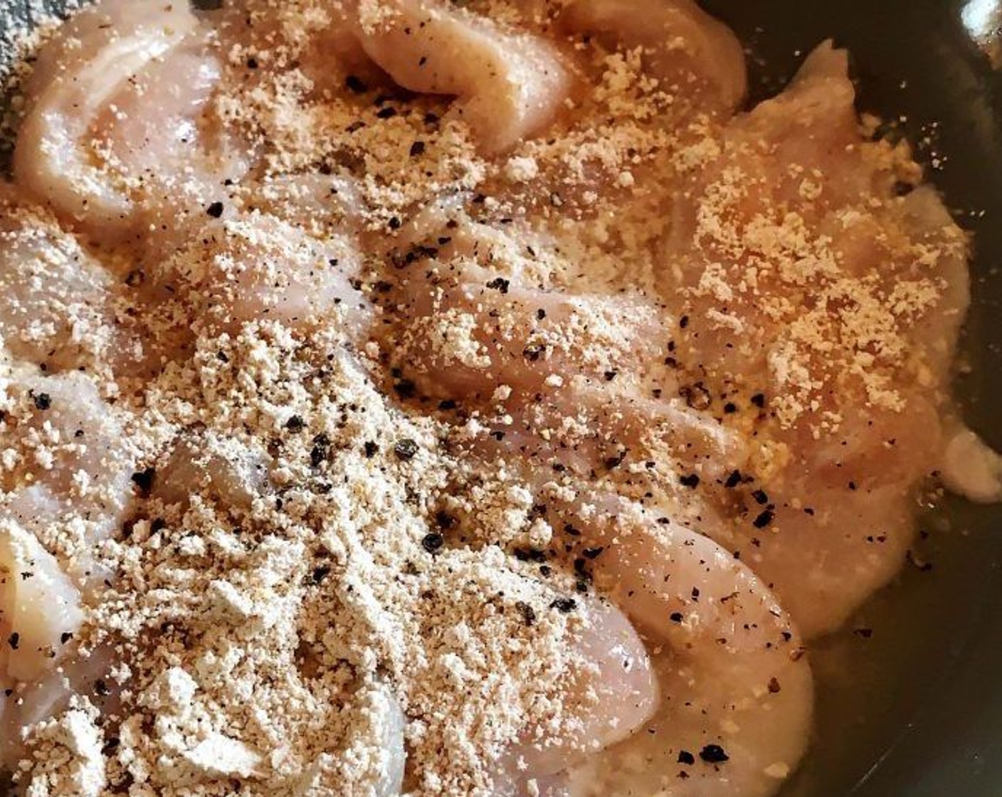 step 2 In a skillet, heat up the Extra-Virgin Olive Oil (1 Tbsp). Dust the chicken with Tapioca Starch (2 Tbsp) and some extra Ground Black Pepper (to taste).