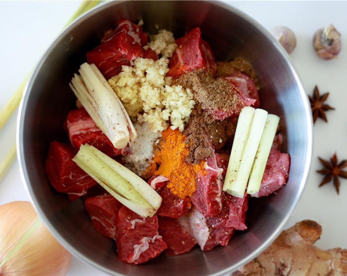 step 3 Place the Cubed Beef in a bowl and add Fish Sauce (2 Tbsp), smashed and cut Lemongrass (1), Fresh Ginger (1), {@10:}, Black Peppercorns (1 tsp), Sea Salt (3/4 tsp), Ground Turmeric (1/2 tsp), Ground Cinnamon (1/2 tsp), Ground Cumin (1/2 tsp), Sweet Paprika (1/2 tsp), and Fennel Seeds (1/4 tsp). Mix well, and set aside.
