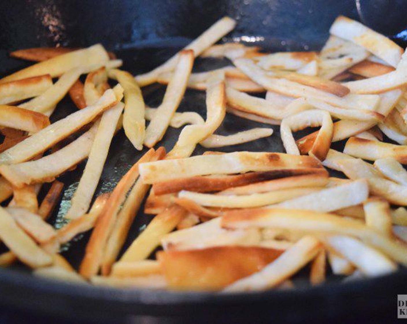 step 3 Place a medium-sized cast iron skillet over medium heat and then add the oil. Let the oil heat up for about 1 minute and then add the tortilla strips. Fry the strips for about 3 minutes, stirring constantly, until they are crunchy and golden brown.