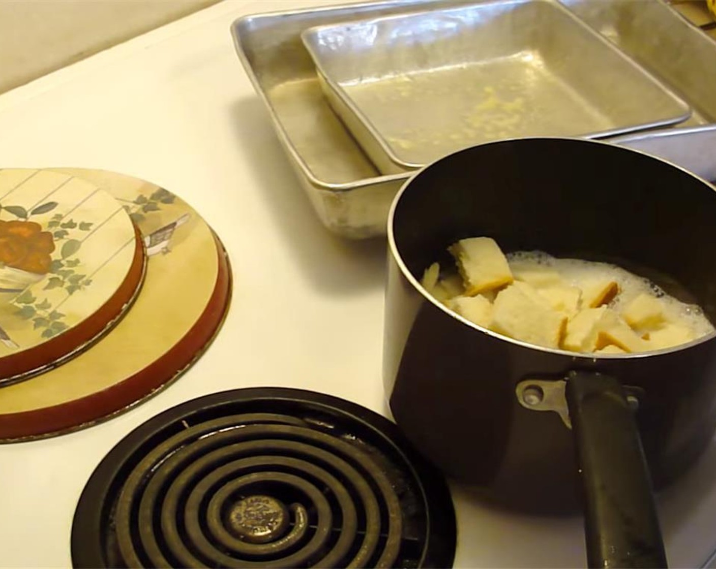 step 2 Put 2 cups of water into a 9 x 13 inch pan. Grease an 8 x 8 inch pan with cooking spray. Add bread to the milk. Stir, and let bread soak for a few minutes.