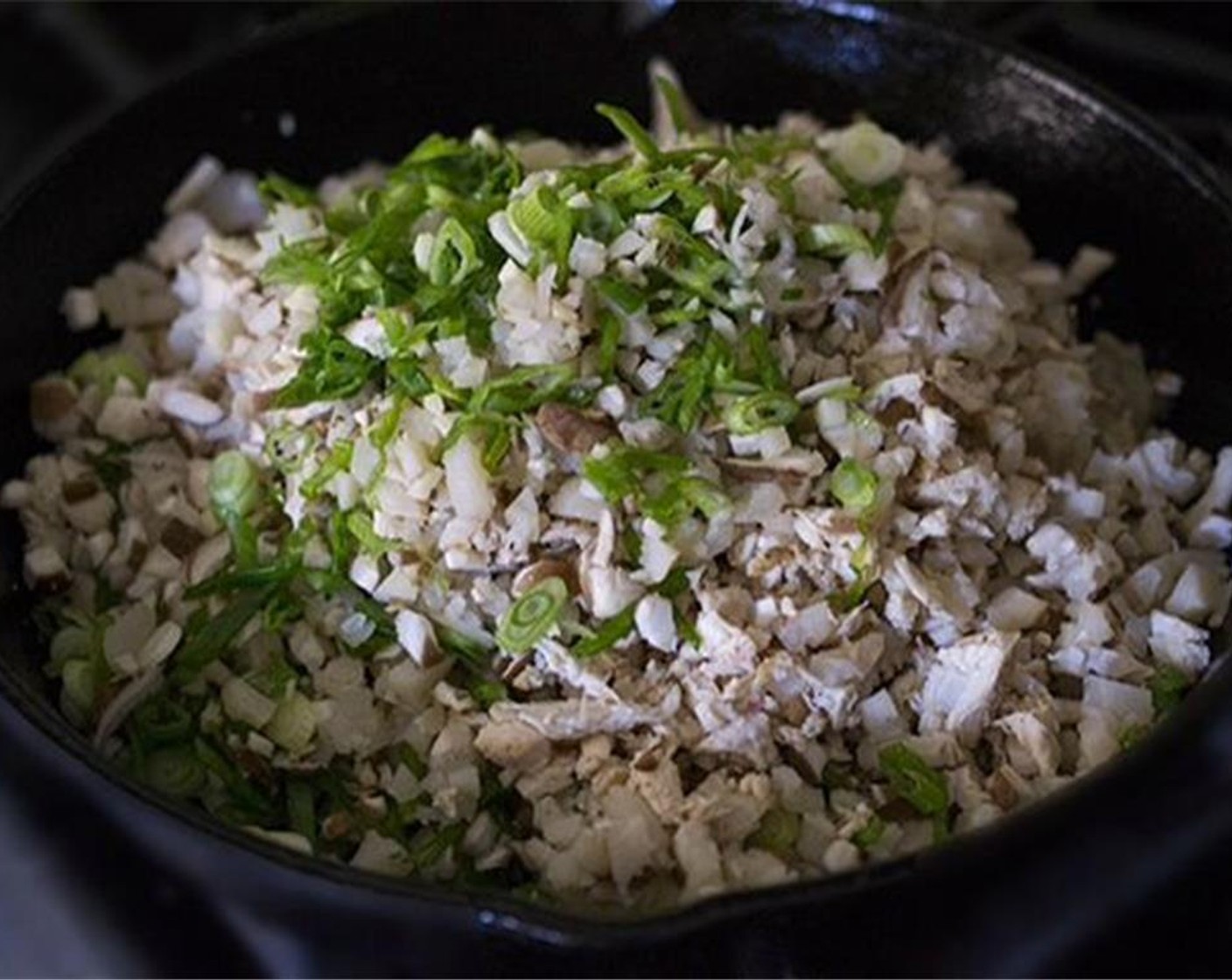 step 7 Reheat the pan you used to cook the chicken, adding more oil if needed.  Add the Garlic (1 clove) Scallion (1 bunch), Water Chestnuts (1 cup), and Shiitake Mushrooms (8). Sauté about 3 minutes or until warmed through.