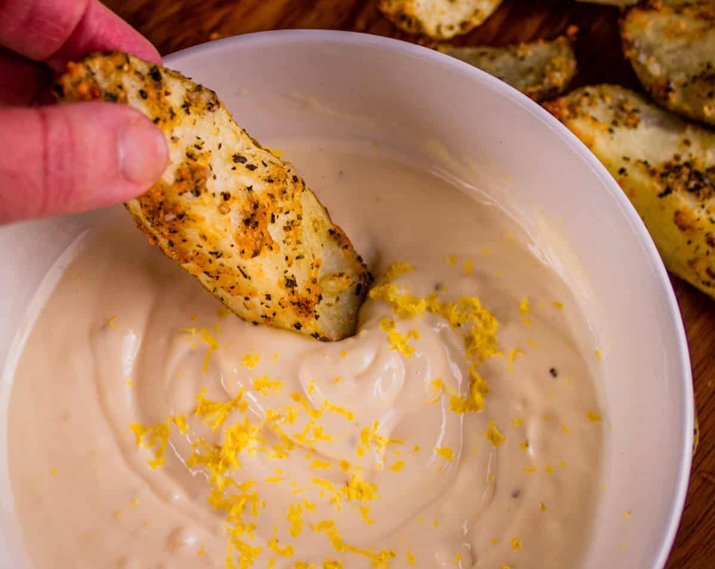 step 6 While potatoes are roasting, combine Mayonnaise (1 cup), Garlic (1 tsp), Lemon (1), Kosher Salt (1 pinch), and Ground Black Pepper (1 pinch) in a small bowl. Whisk together until well combined. Serve as a dipping sauce for the crispy potato wedges.