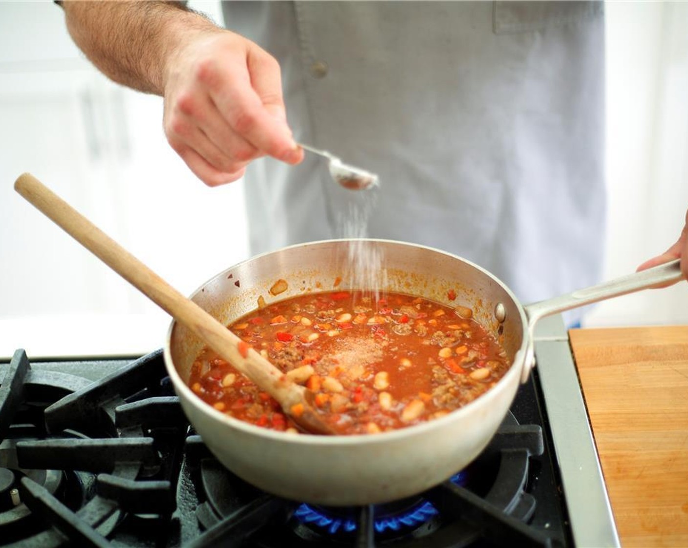 step 6 Add Canned Crushed Tomatoes (3 1/3 cups), Chipotle Chili Puree (1/4 cup), cannellini beans, 1 cup water, 1 teaspoon salt and 1/2 teaspoon pepper. Increase heat to high and bring to boil. Then, reduce heat to low and simmer for 20 minutes. Stir occasionally.