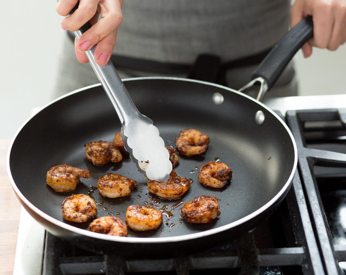 step 10 Heat a large non-stick sauté pan withCanola Oil (1/2 Tbsp) over medium-high heat. When hot, add the shrimp in a single layer and cook for 3 to 5 minutes, stirring occasionally. When the shrimp are pink and opaque, remove from heat and keep warm for plating.