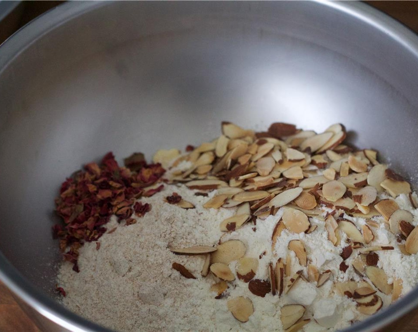 step 2 In a medium bowl, add the almonds, Fine Sea Salt (1/2 tsp), Granulated Sugar (1/2 cup), Whole Wheat Pastry Flour (1 cup), Unbleached All-Purpose Flour (1 cup), and Edible Dried Rose Petals (1 Tbsp) and whisk together. Set aside.