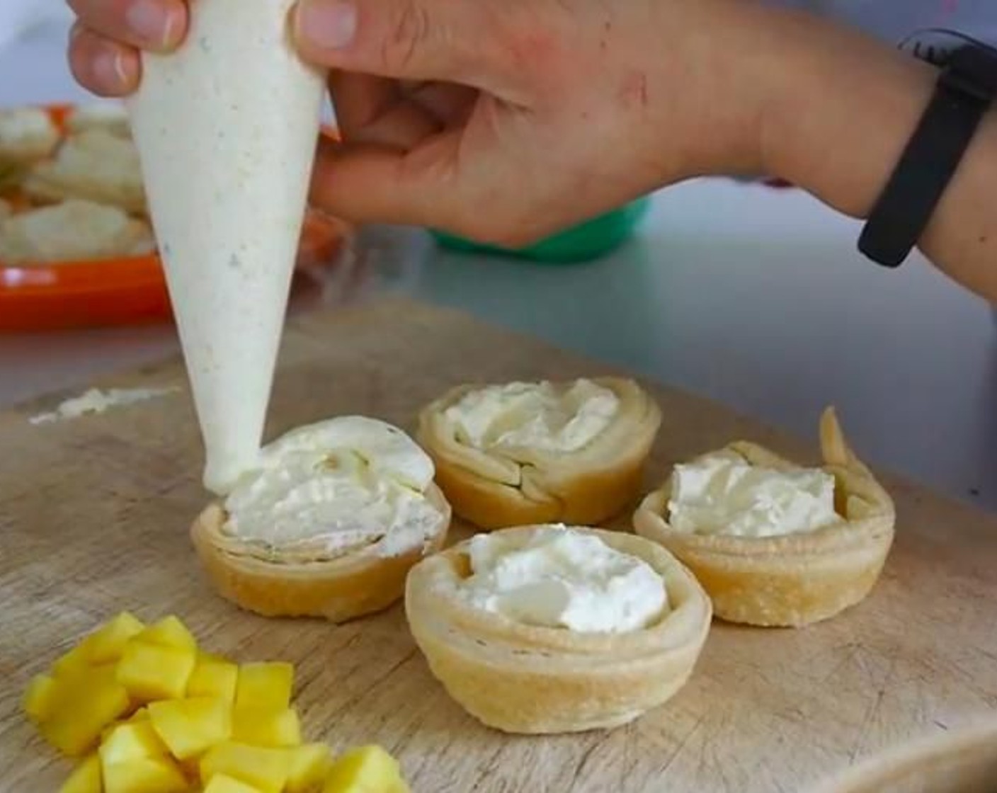 step 9 Next day using a piping bag add more cream on top swirling around the tart. Finish by adding 3 pieces of sweet mango for decoration and sprinkling more Lime (1). I also like to add a small mint leaf on one side.