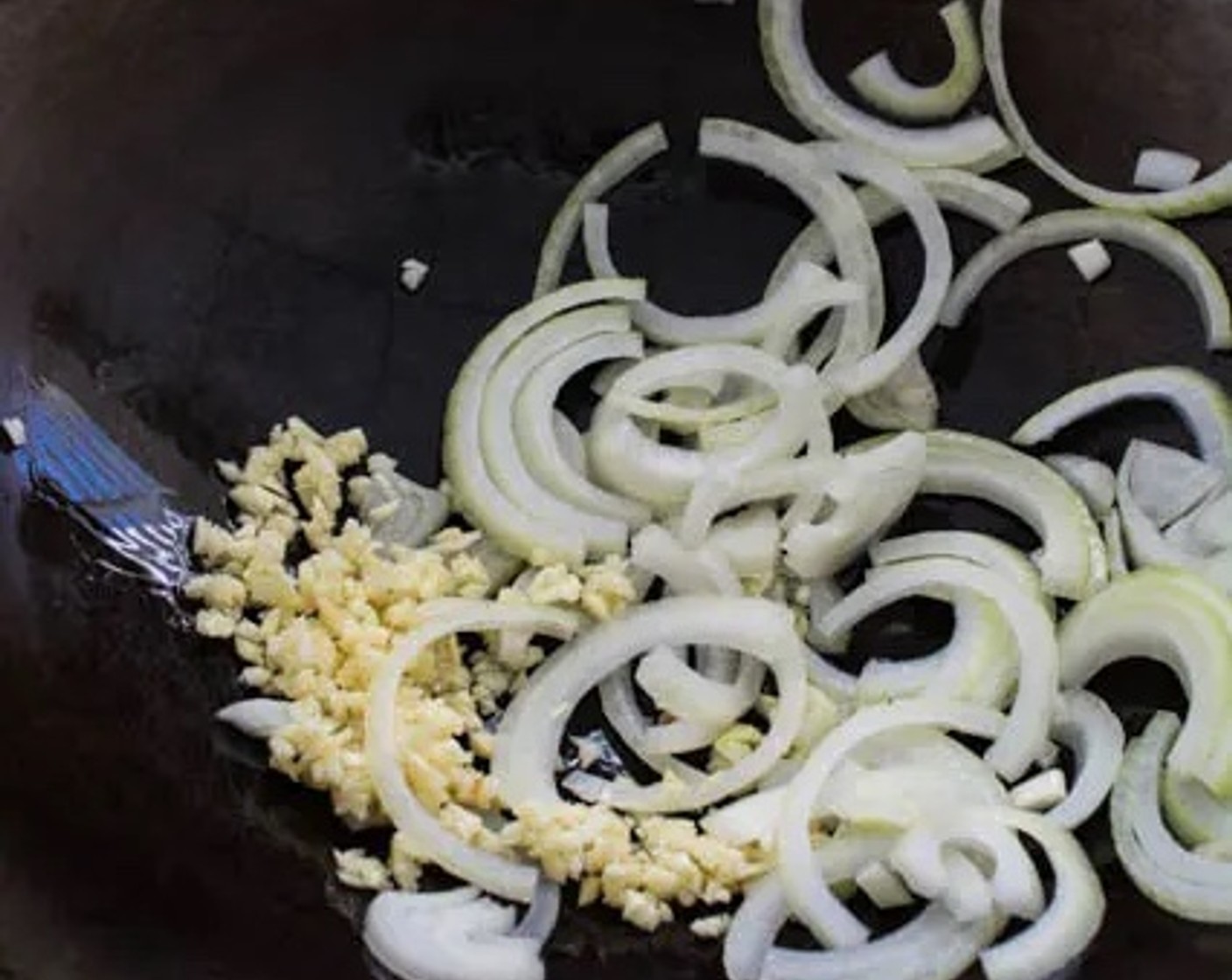 step 1 Heat Cooking Oil (2 Tbsp) in a wok over medium-high heat. Add Onion (1) and Garlic (3 cloves) to the wok. Stir-fry for 1 minute to allow the onion sliced to soften.