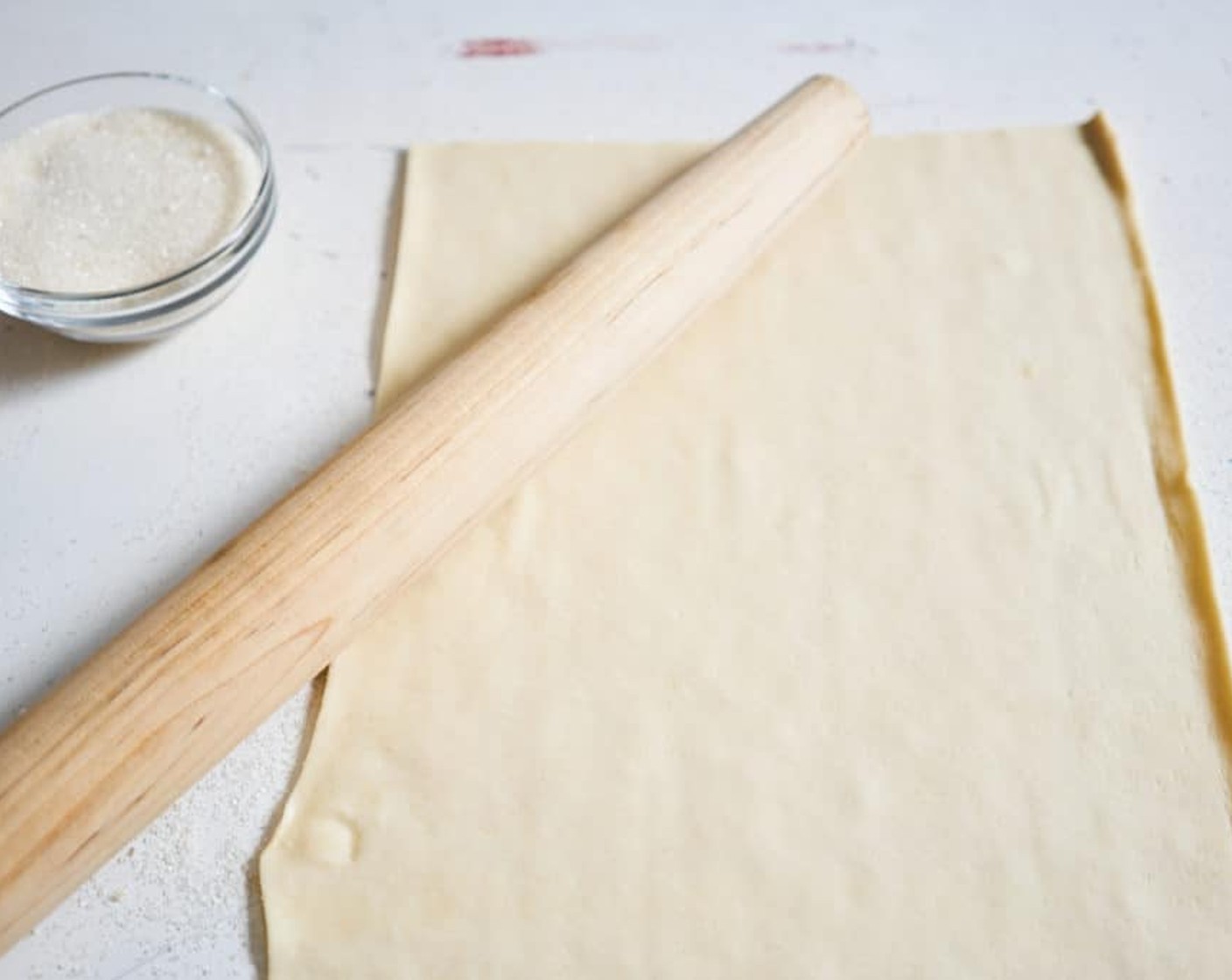 step 1 Sprinkle a cool, flat surface with Granulated Sugar (1 cup). Gently open up the sheet of Puff Pastry (2 sheets) and lay flat on top of the layer of sugar. Sprinkle sugar evenly all over the sheet of puff pastry.