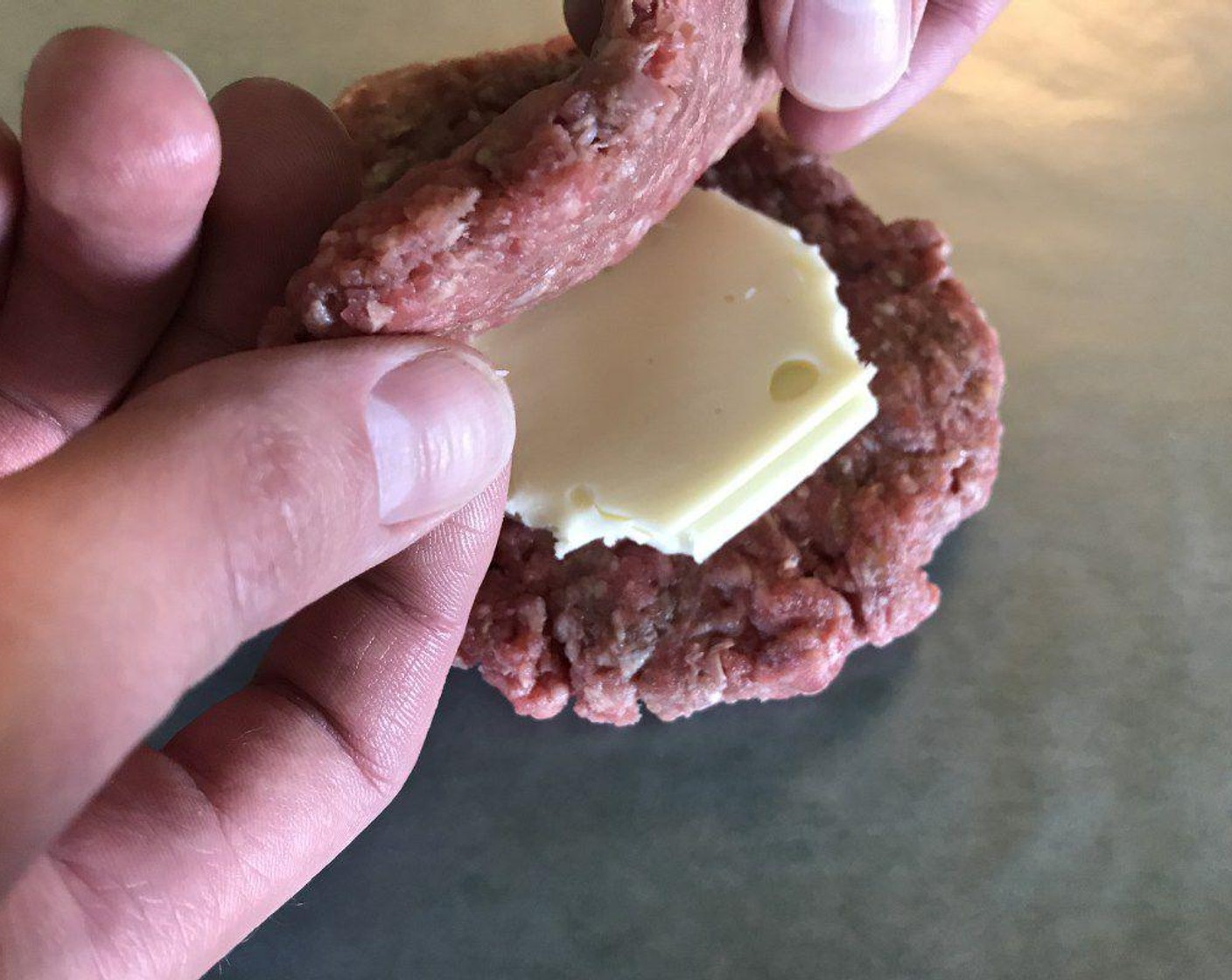 step 4 Form small circles of cheese that will fit inside the patties. White Cheese (4 slices) on 4 of the patties and sandwich the cheese with the other 4 patties on top.