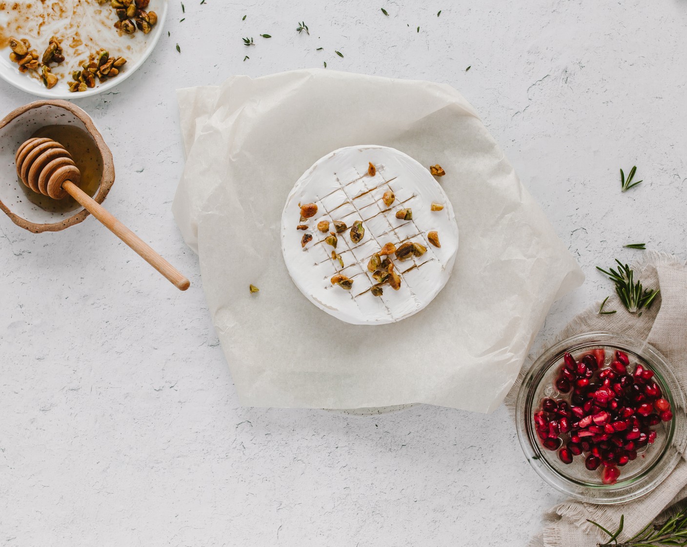 step 5 Once the inside of brie is nice and melty, score the top and add your pistachios. Then, layer on some Pomegranate Seeds (1/4 cup).