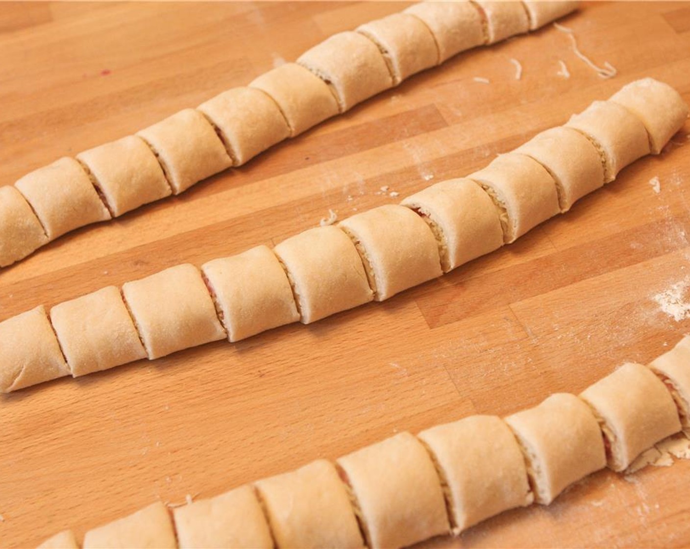 step 7 Cut into twelve 1-inch pieces and transfer to a baking sheet lined with parchment paper. Repeat with remaining 3 portions of dough. Let rest, uncovered, at room temperature for 30 minutes.