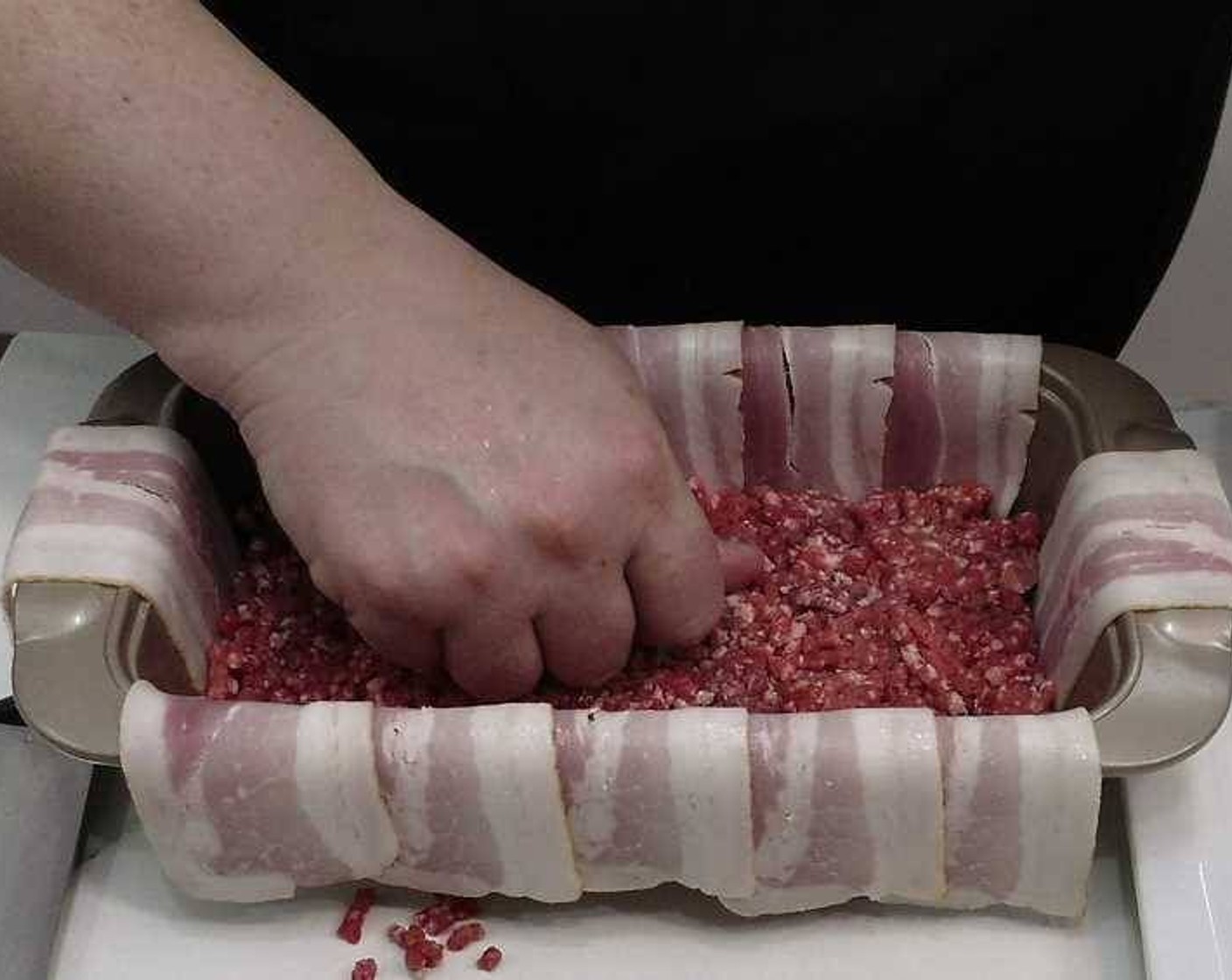 step 5 Cover the mold you will be using to bake with strips of Bacon (7 slices), covering as much as possible. Add the Ground Beef (2.2 lb) and pack towards the bottom until it reaches 1/3 of the height of the baking mold.