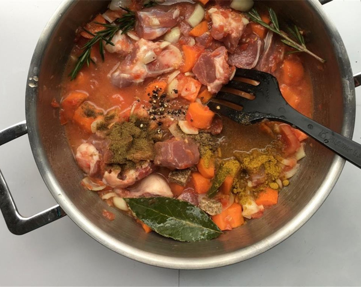 step 4 Stir well again. Pour in the Beef Stock (1 cup) and season with a good dash of freshly ground black Ground Black Pepper (to taste), a pinch of Salt (to taste), the Ground Cumin (1 tsp), Ground Cinnamon (1/4 tsp), Curry Powder (1 tsp) and Ground Coriander (1 tsp).