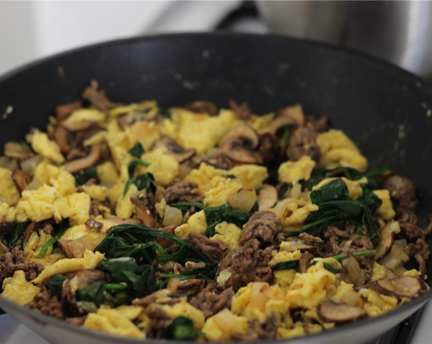 step 7 Spray pan with coconut oil and set over medium heat. Pour in eggs and let set, then stir to scramble. When soft scrambled, add meat and veggie mixture back to pan and stir to combine.