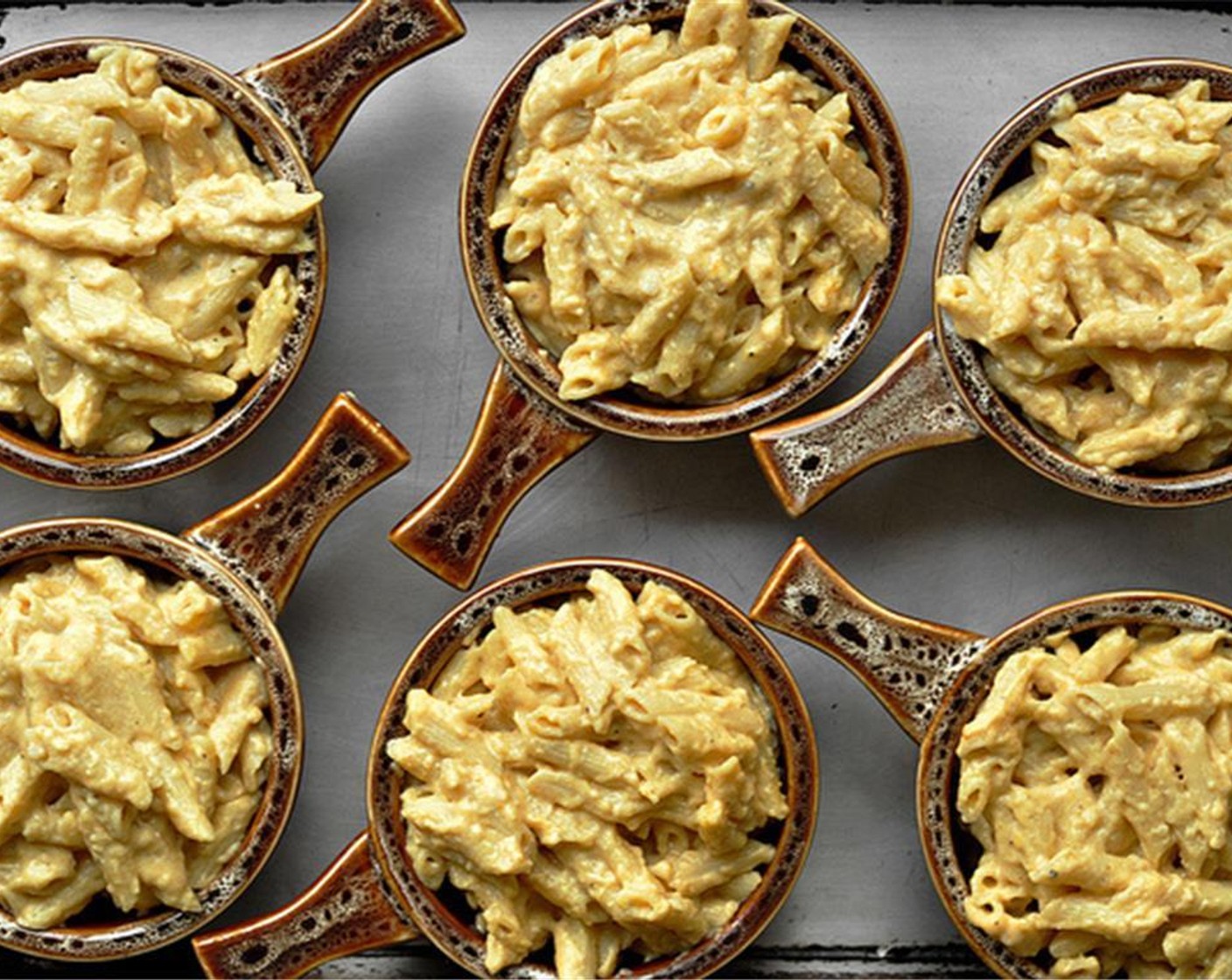 step 8 Add the cooked penne pasta and stir to combine. Pour into the baking dish or portion out into the individual ramekins. Top with reserved cheddar cheese and parmesan cheese.