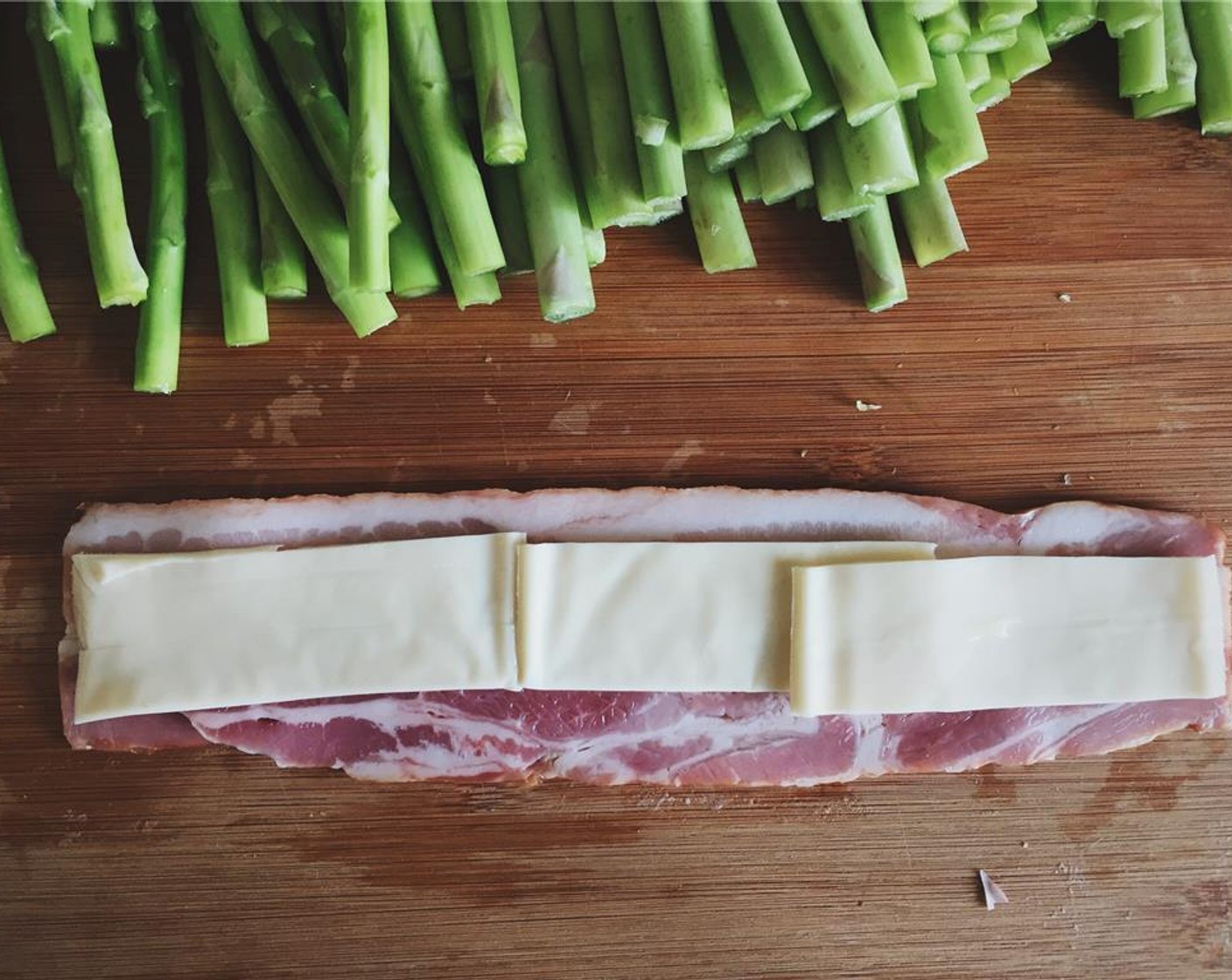 step 6 Optional step for cheese lovers: slice the Mozzarella Cheese (3 slices) into thin slices and put them on a whole bacon then put asparagus on top.