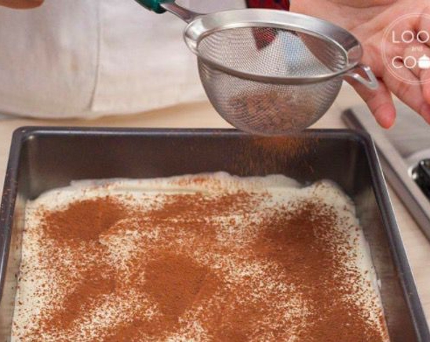 step 10 Pour half of the tiramisu mixture over it and spread evenly. Sprinkle Unsweetened Cocoa Powder (to taste) on top.