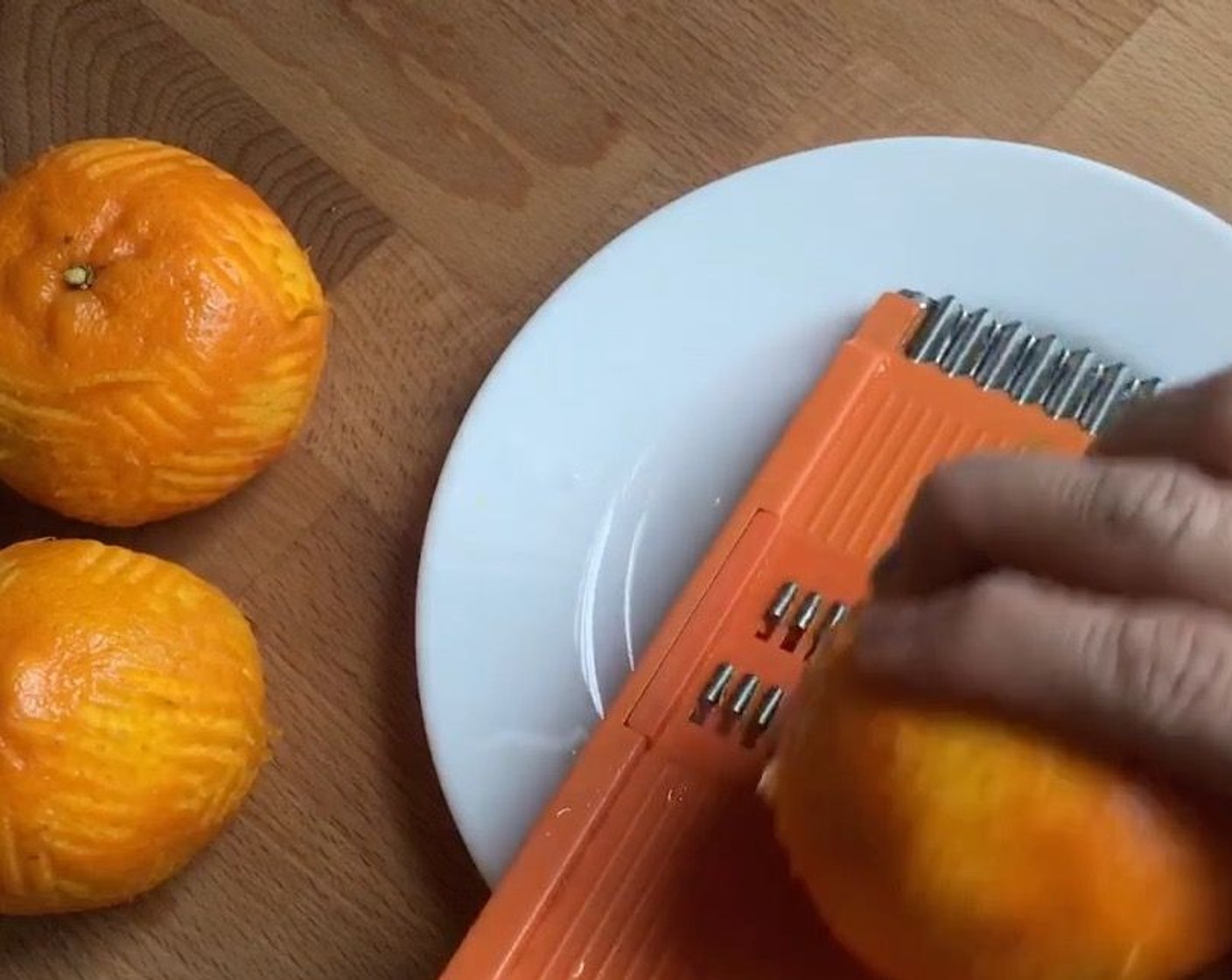 step 1 First, clean and rinse well the Mandarin Oranges (3). Then using a vegetable shredder, grate the orange rind.