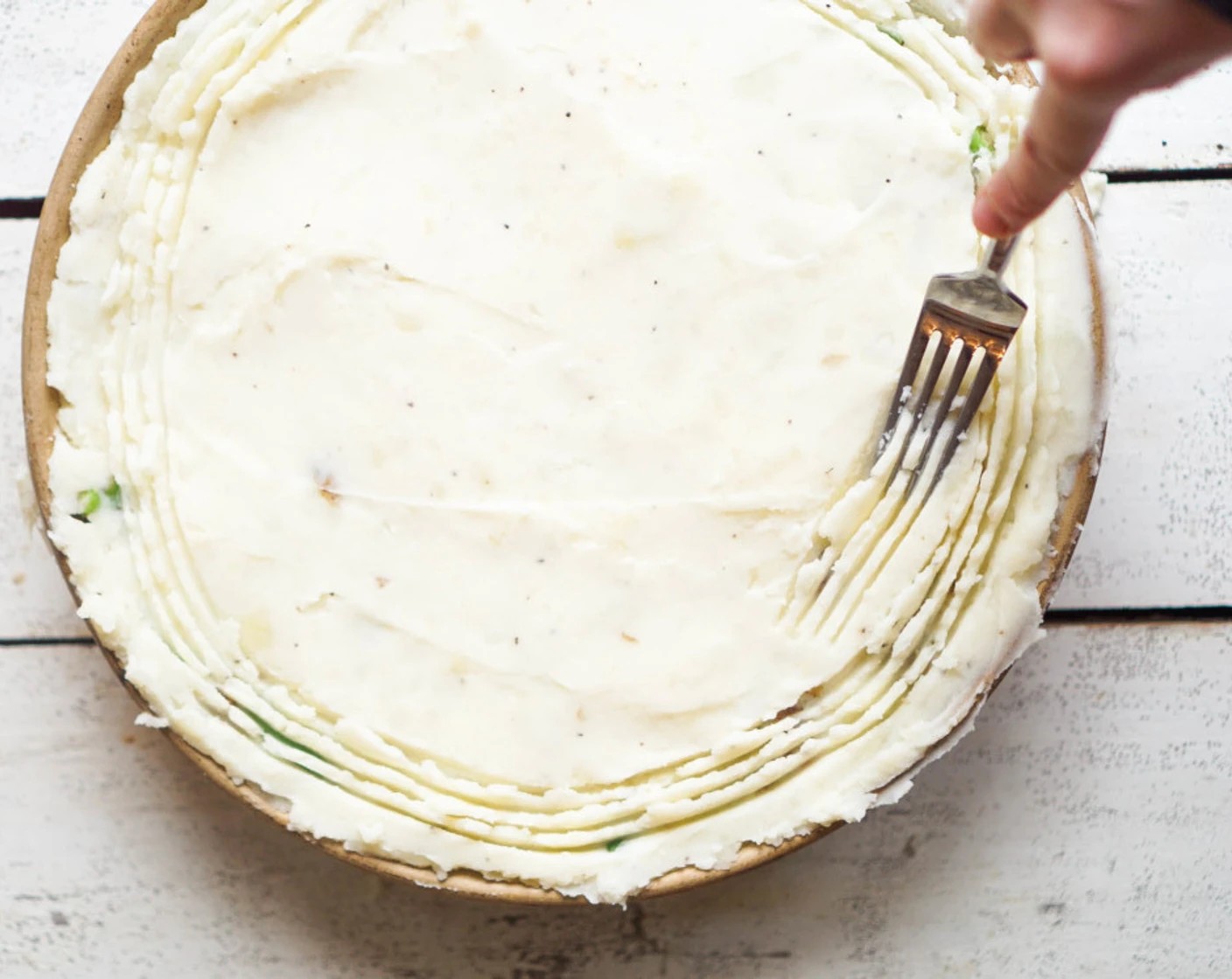 step 9 Transfer the filling to a 9x9 baking dish or 12-inch round dish. It can also be cooked and baked in a cast-iron skillet. Spoon over the mashed potatoes and spread evenly, smoothing the top with the back of a spatula or spoon. If desired, use a fork to create a swirl pattern in the potatoes. Bake for 30 minutes.