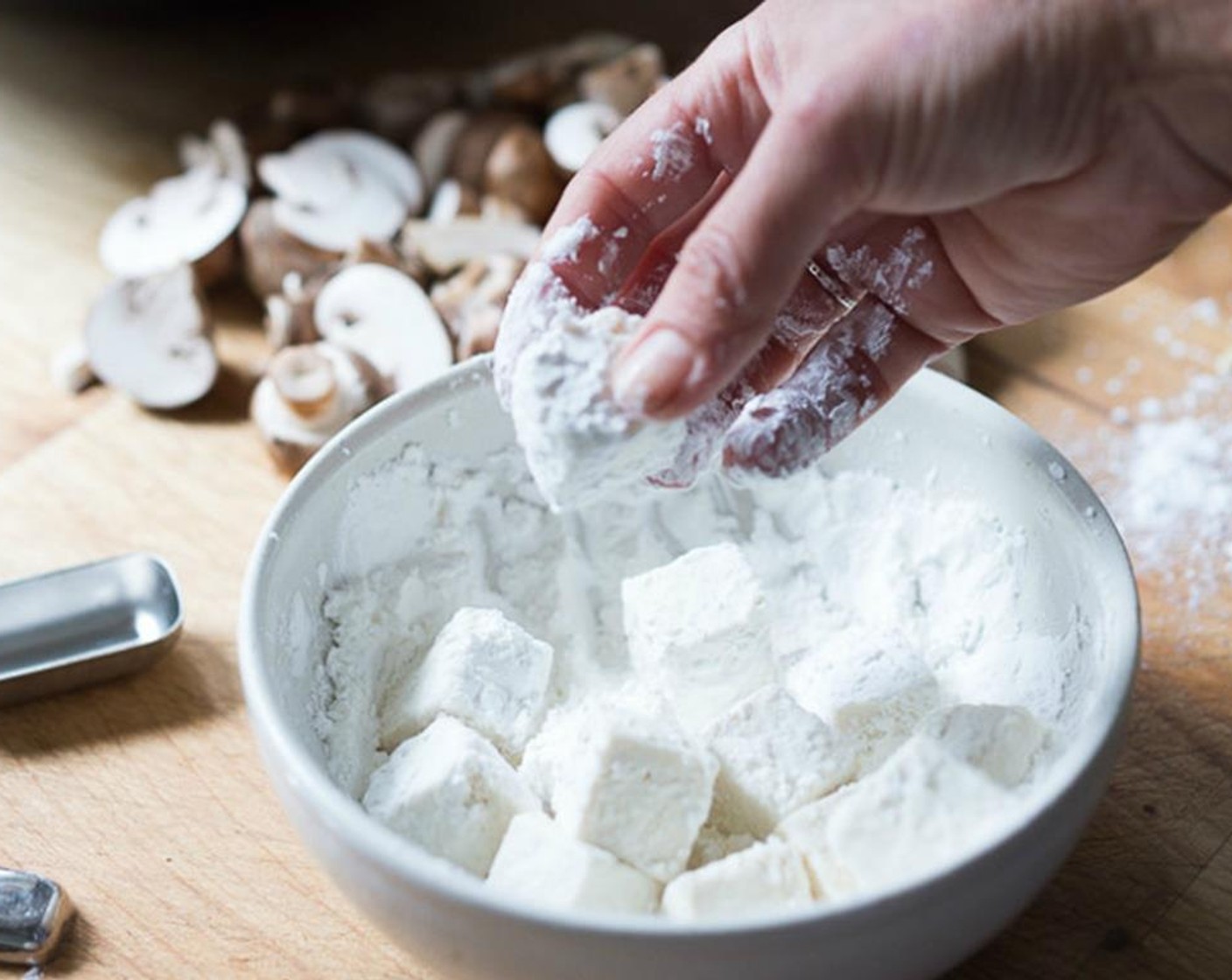 step 3 Place Corn Starch (1/2 cup), Salt (3/4 tsp) and Granulated Sugar (3/4 tsp) in a medium bowl and mix well. Toss tofu in the cornstarch mixture. Heat around 2-3 Tbsp of Peanut Oil (as needed) in a wok over high heat. Once hot, turn the heat to medium-high.