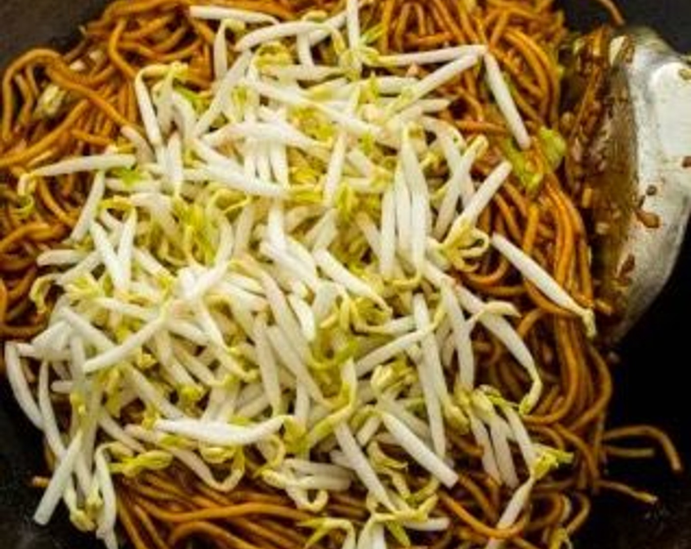 step 8 Add Bean Sprouts (1 1/2 cups) to the wok. Stir to combine all the ingredients well, then transfer the noodles to a serving dish.