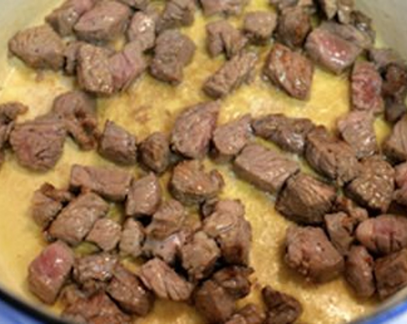 step 4 Add Olive Oil (2 Tbsp) to a hot dutch oven/large pot. Brown the beef pieces on all sides in batches and once they're browned well, remove them with a slotted spoon and set them aside on a plate. Repeat until the beef is browned.
