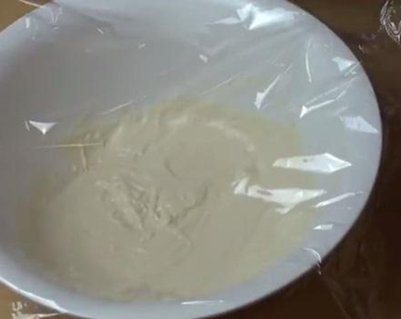step 2 Into a large mixing bowl, add the All-Purpose Flour (1 1/2 cups), Salt (1 pinch), Milk (1/2 cup), Water (1/2 cup) and the yeast mixture. Whisk everything together until combined. Cover the bowl with a thin film, and set aside for about an hour