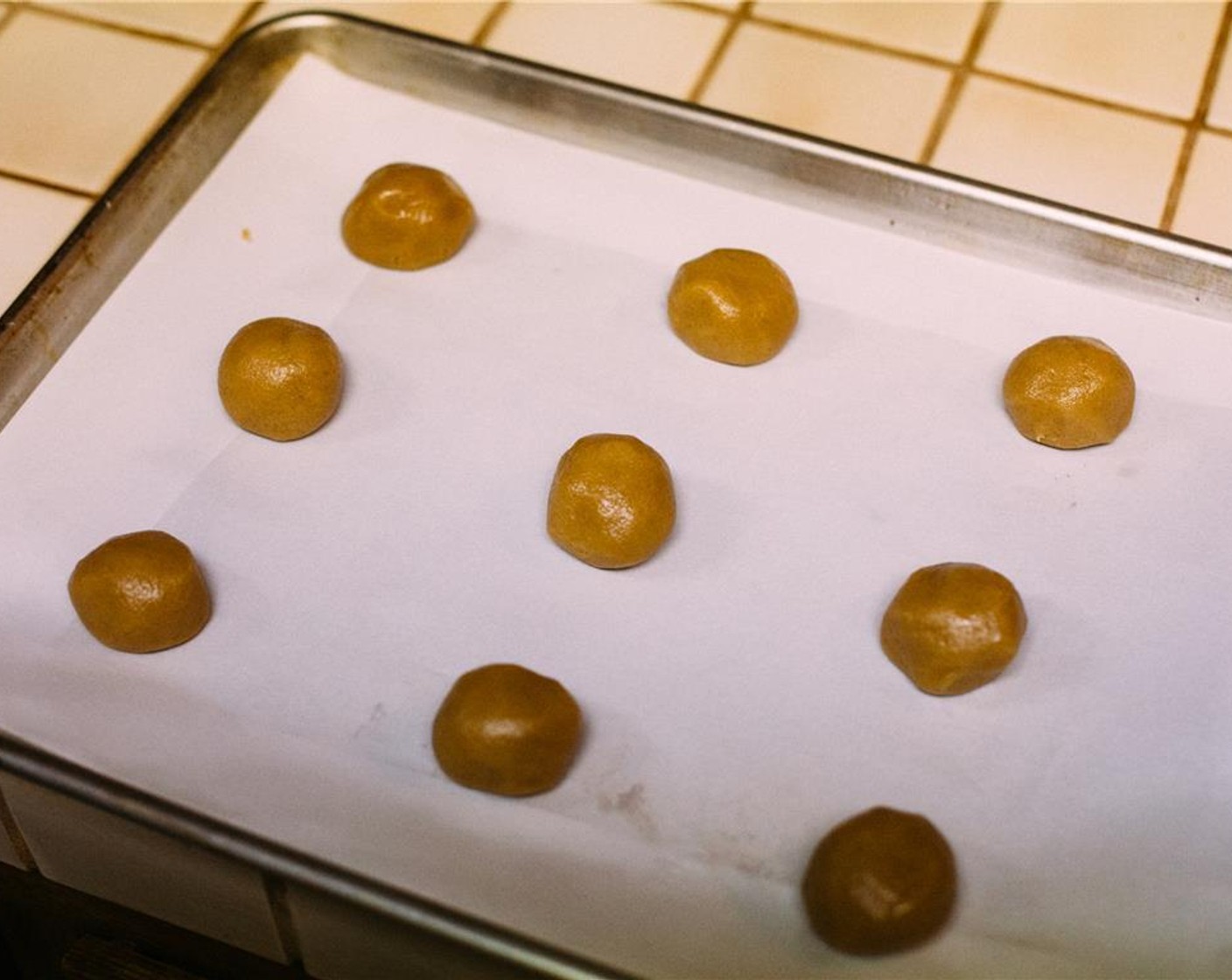 step 7 Form dough into balls about the size of whole walnuts and place 2 inches apart on prepared baking sheets. Bake for 12 to 14 minutes, or until edges are light brown and centers are still wet—don’t overbake.