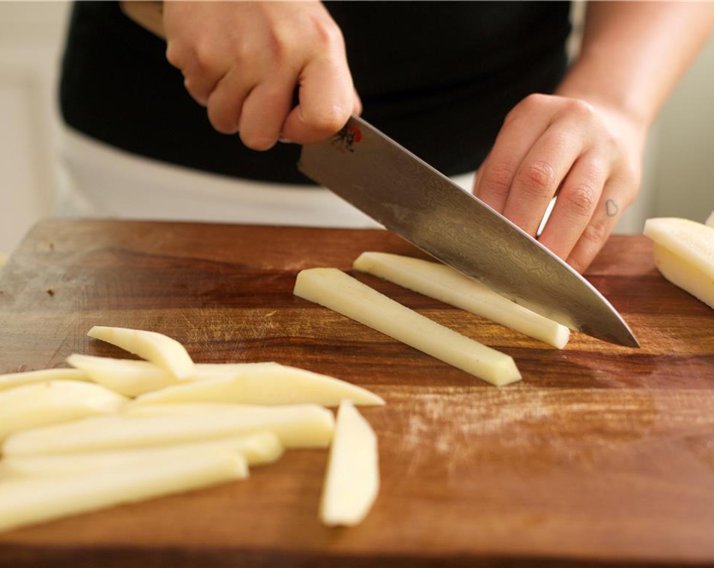 step 4 Fill a medium bowl with cold water. Peel and cut Russet Potatoes (2) lengthwise into quarter-inch slices or planks. Stack several potato planks on top of each other and then cut them lengthwise into quarter inch slices. Place them into the bowl of water to release starch.