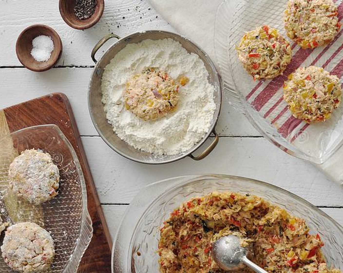 step 10 Portion out the cakes and shape into patties, similar in size. Heat a large skillet over medium-high heat and add enough olive oil to cover the bottom. Dredge the salmon cakes in All-Purpose Flour (1/2 cup), then shake, and place in the pan.