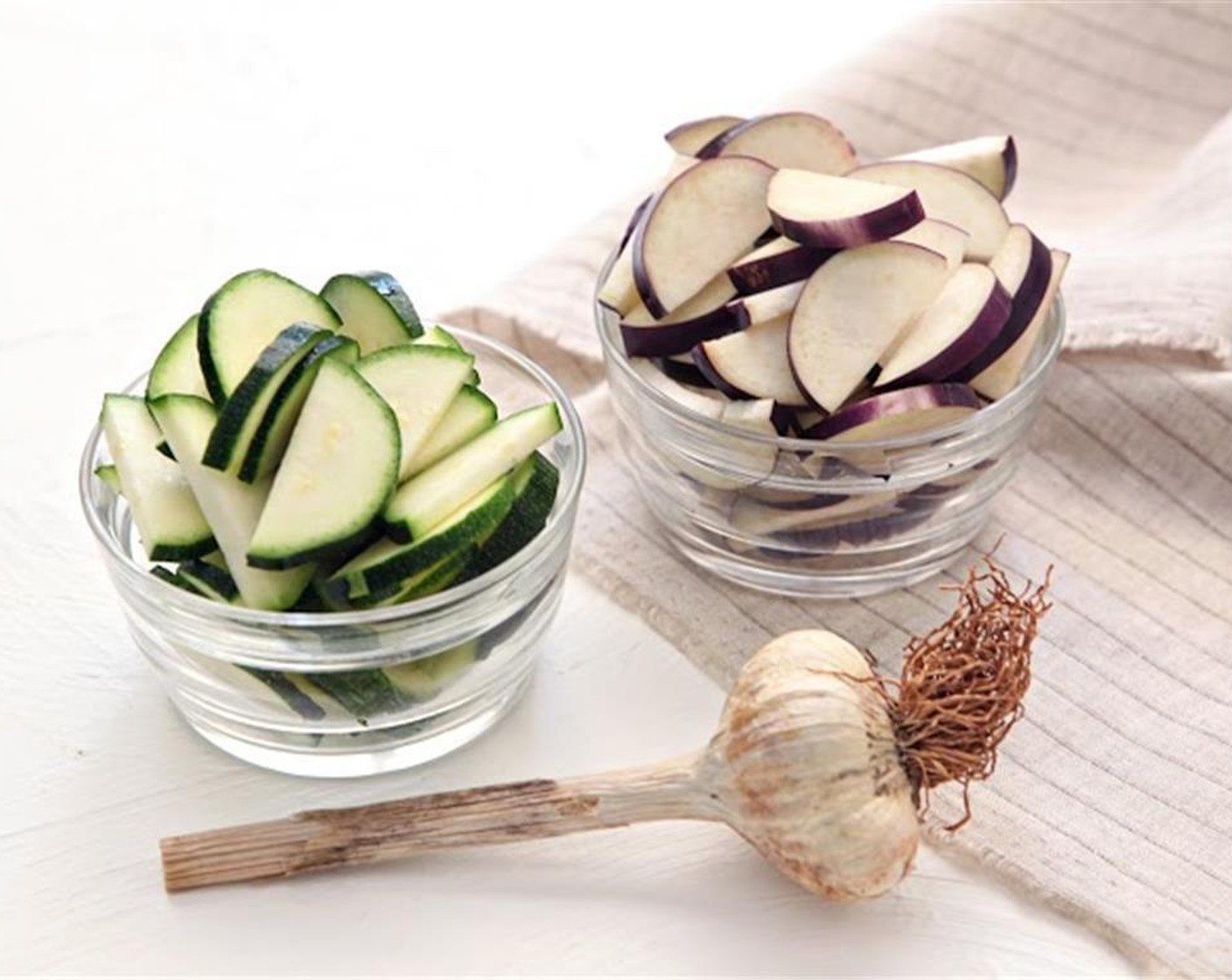 step 1 Grate the Parmesan Cheese (2/3 cup). Remove the leaves from the Italian Flat-Leaf Parsley (2 sprigs) and roughly chop. Halve and slice the Zucchini (1), Onion (1), and Japanese Eggplant (1). Mince the Garlic (2 cloves).