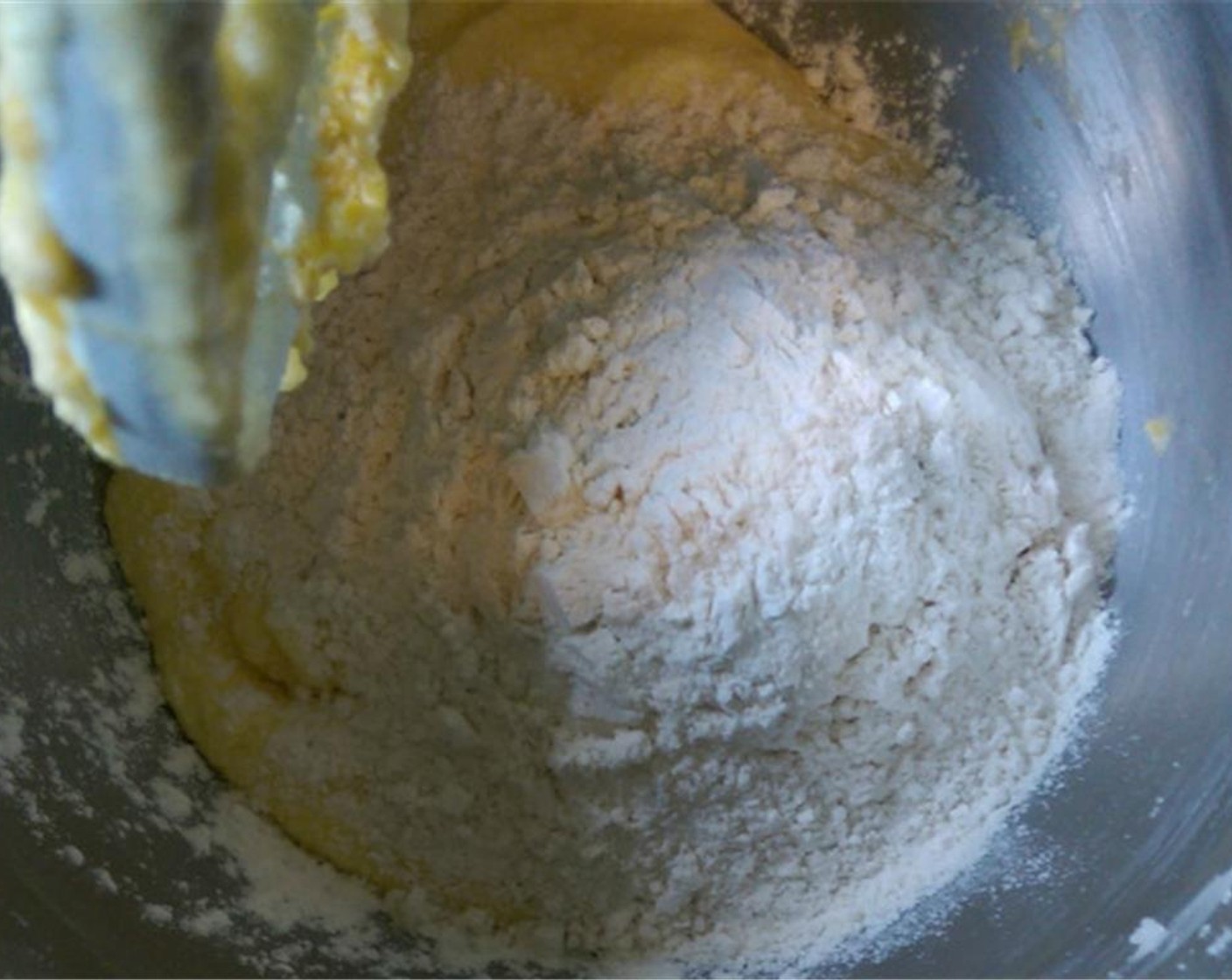 step 6 In another bowl, whisk together Unbleached All Purpose Flour (2 cups), Baking Powder (1/2 Tbsp), and Salt (1/2 tsp). After scraping down the sides of the bowl, alternate between the dry ingredients and Plain Yogurt (1 cup).
