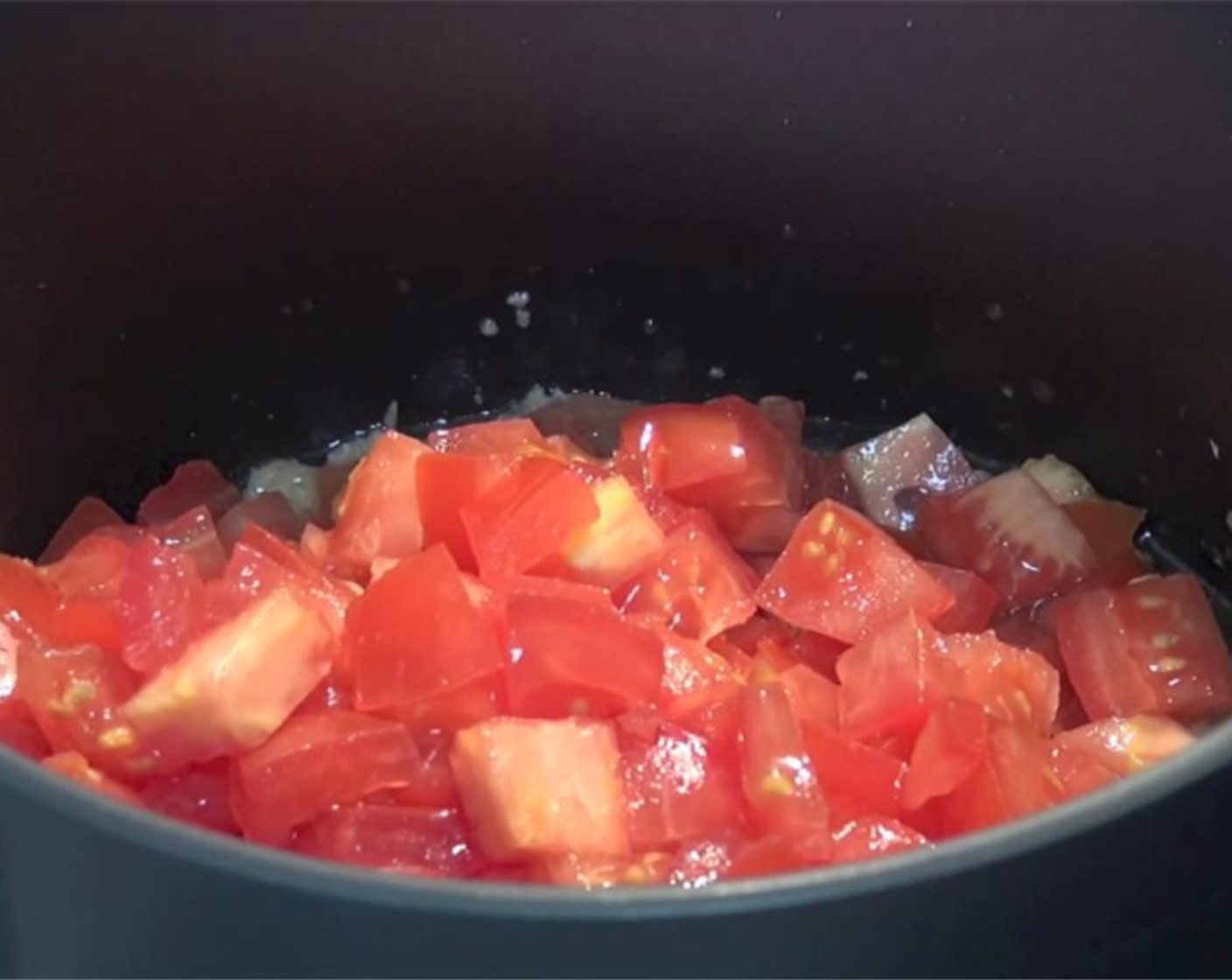 step 2 Add the diced tomatoes into the saucepan.