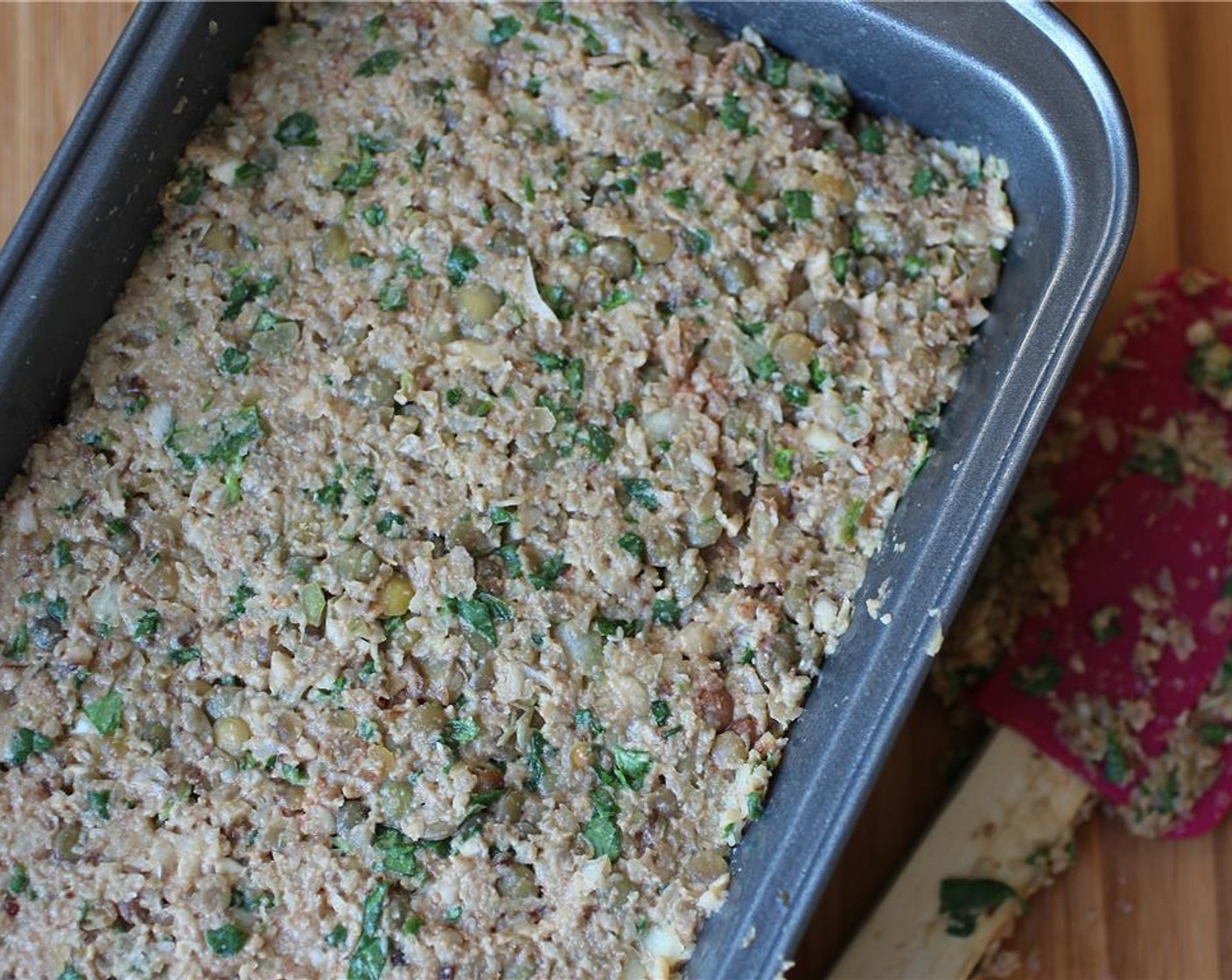 step 4 Mix everything well until all the ingredients are incorporated and everything starts sticking together. Take a bread pan, and spray it with oil. Mold the loaf into the pan and make sure it’s spread evenly so it cooks evenly too.