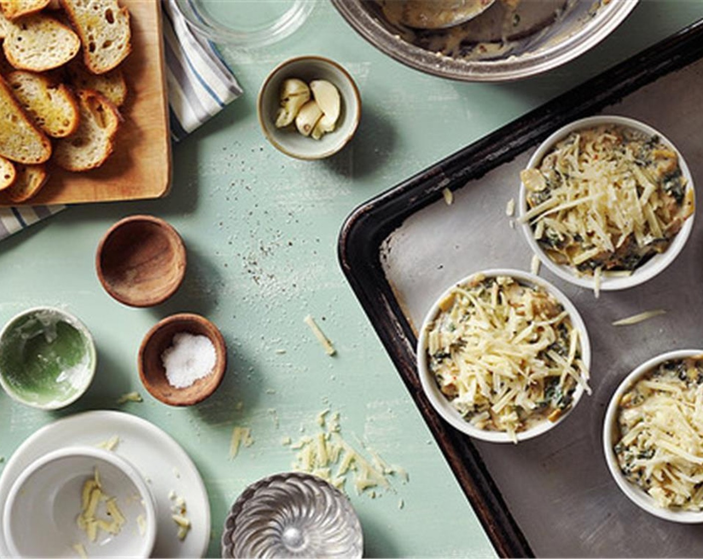 step 12 Divide the dip into four ramekins or one large baking dish. Top with reserved cheese, and place on a baking sheet.