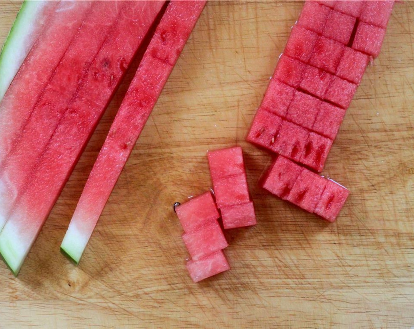 step 1 To dice the Seedless Watermelon (1/2), slice the half into two quarters, and then slice off 1/2" crescent-shaped slabs. Slice the slabs into 1/2" strips, and then into cubes.