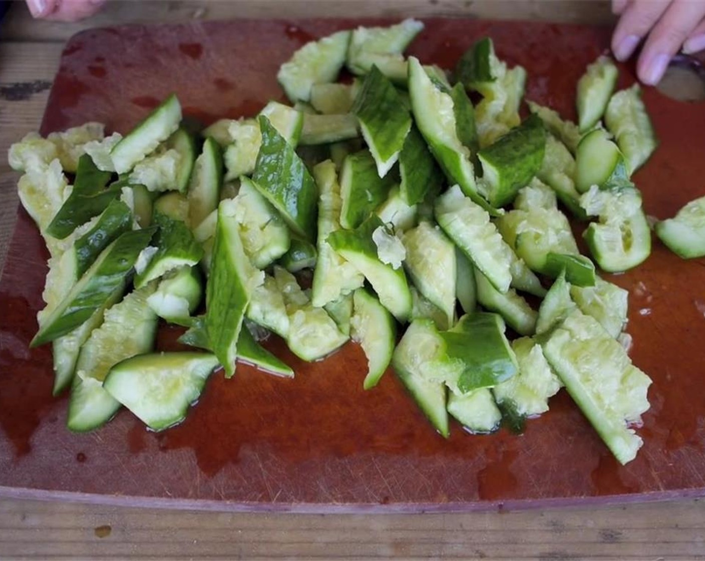 step 2 Cut the ends of the Small Cucumbers (5), then bash them with a pestle until they crumble apart. Place in a sieve over a bowl, sprinkle with Sea Salt (2 Tbsp) and then let sit in refrigerator for 15 minutes.