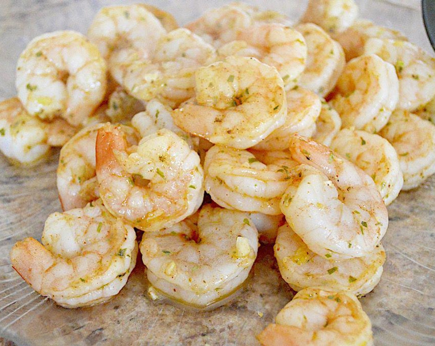 step 3 Add the Jumbo Shrimp (1.5 lb) and let them cook until pink and opaque for about 3 minutes. While they cook, also add in the Garlic (3 cloves), Shallot (1), zest of the Lemon (1/2), Old Bay® Seasoning (1/2 tsp), Dried Tarragon (1/2 tsp), Salt (1 pinch), and White Wine (1 Tbsp). Then use a slotted spoon to remove the shrimp to a plate and set aside.