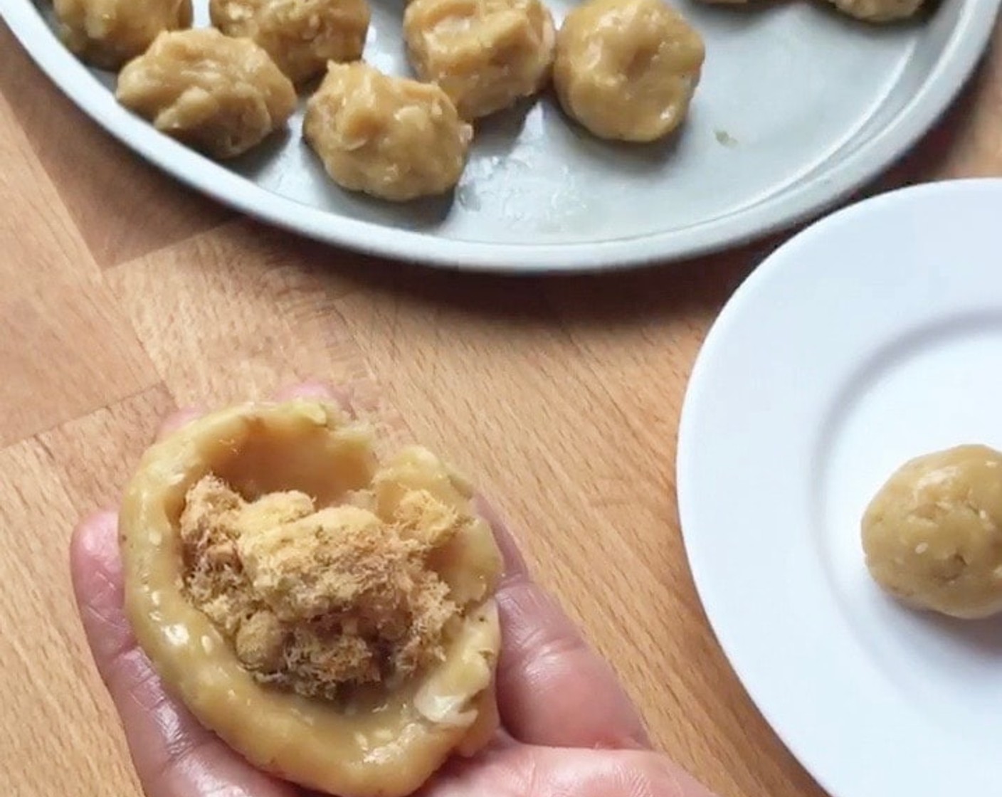 step 11 Wrap a teaspoon of Chicken Floss (2 3/4 cups) in each dough ball. Pinch dough to secure the seam.